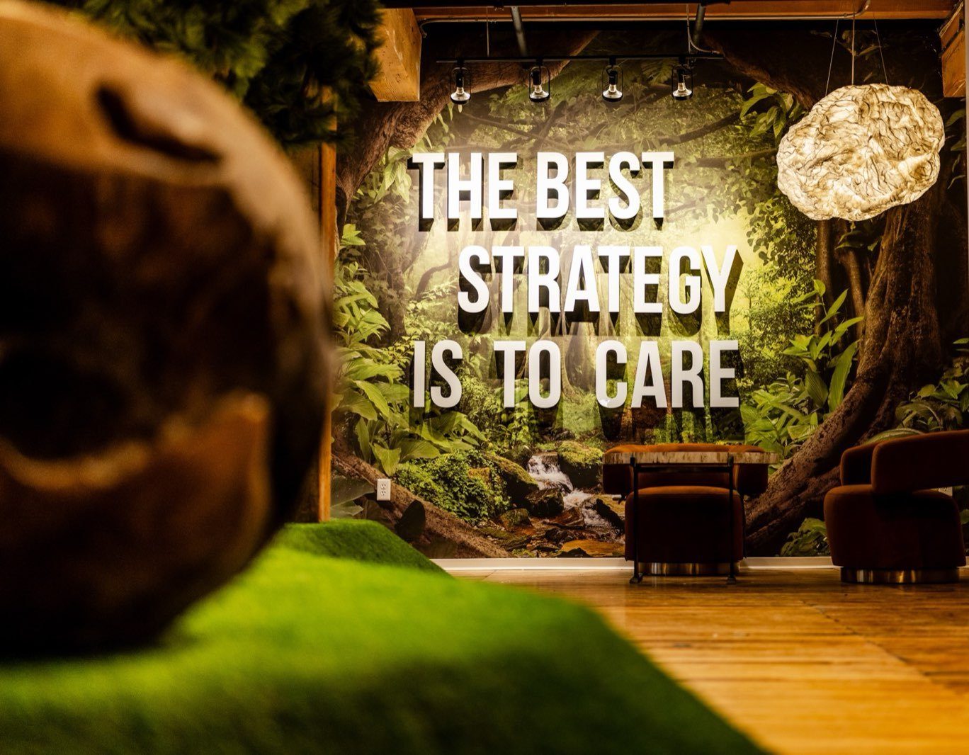 The Media Bridge lounge in the North Loop, its wall reading THE BEST STRATEGY IS TO CARE
