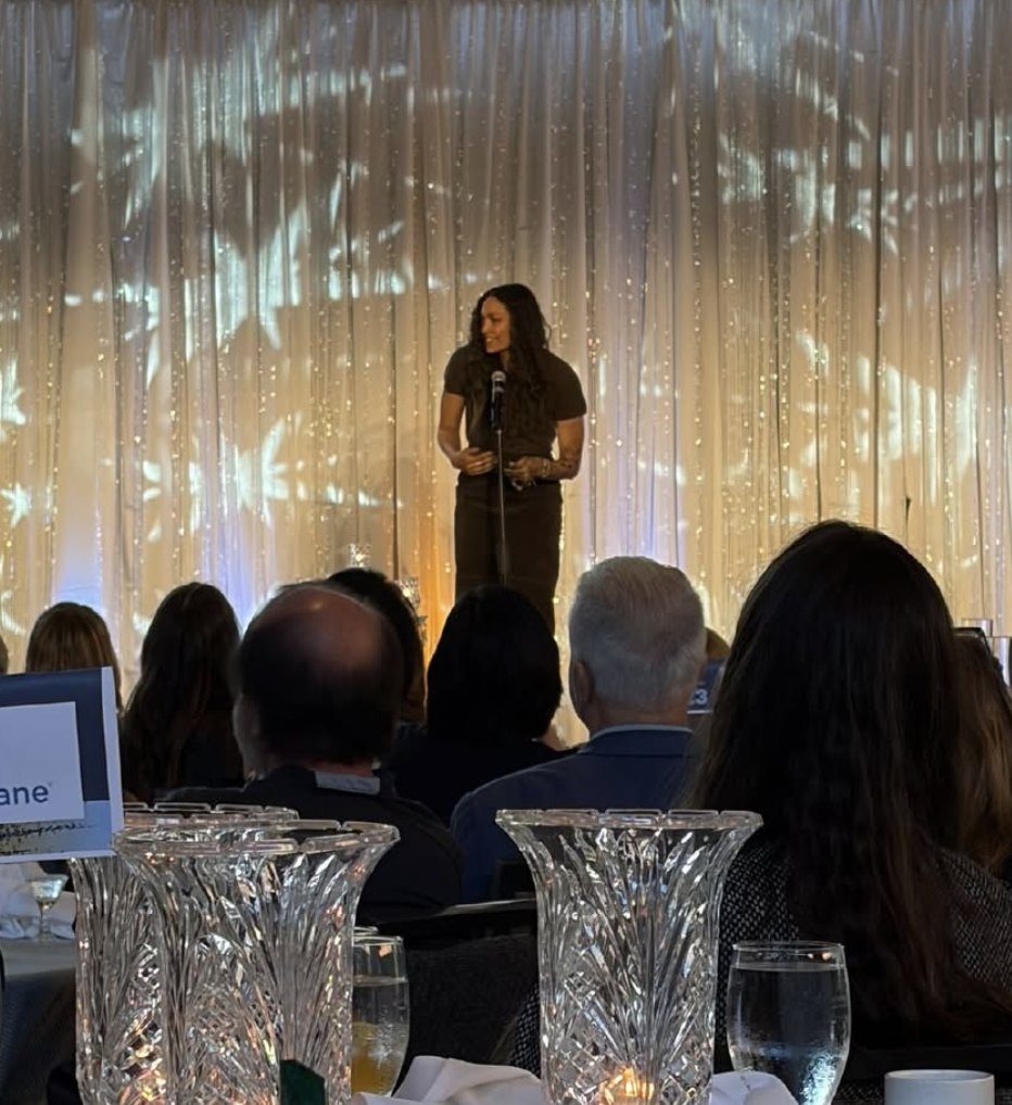 Speaking on stage at an evening event